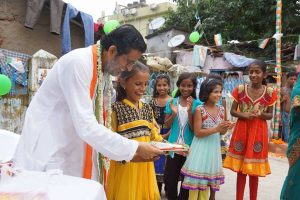 Baba distributing gifts to children
